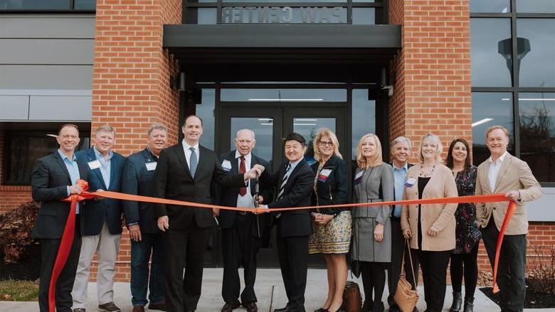Ribbon cutting in front of the PAW Center building at Penn State DuBois