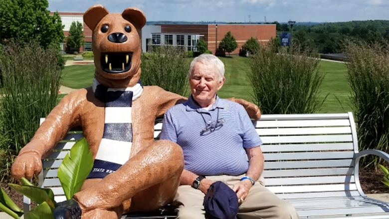 Charles E. Hunnell poses at the Penn State Fayette Lion Bench